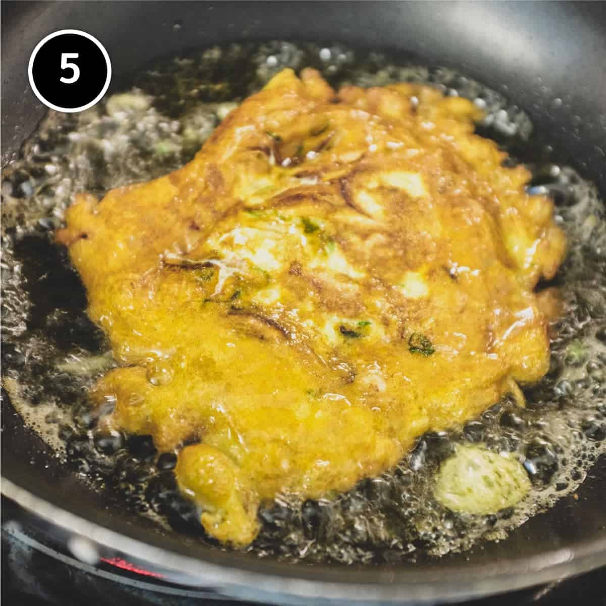 Frying chicken egg foo young patties in hot oil