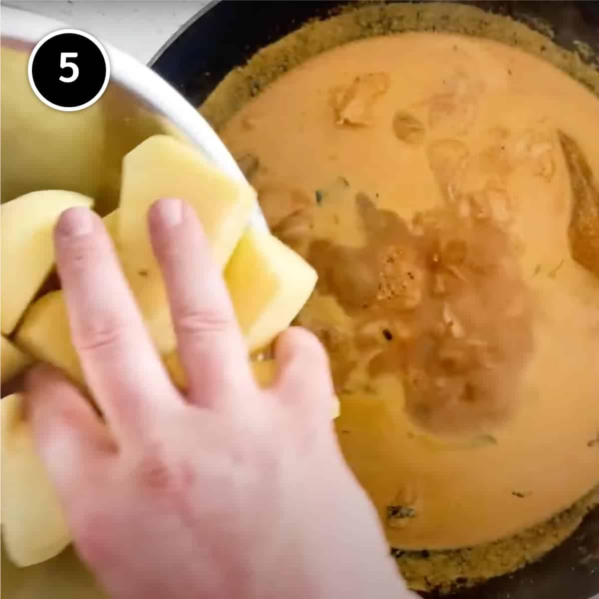 Adding potatoes to Kari Ayam (Malaysian Chicken Curry)