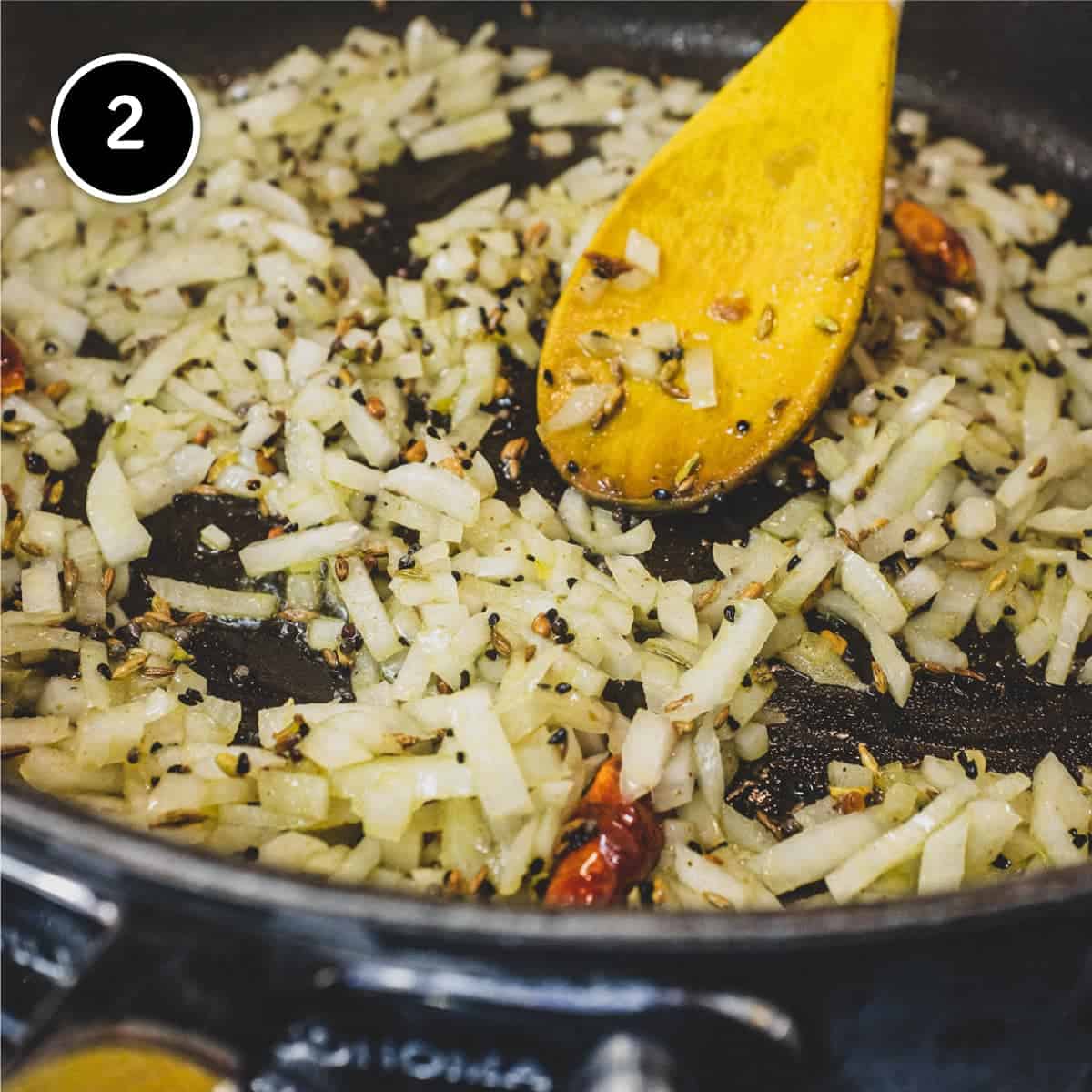 Frying onion with spices for Saag Aloo (Spinach & Potato curry)