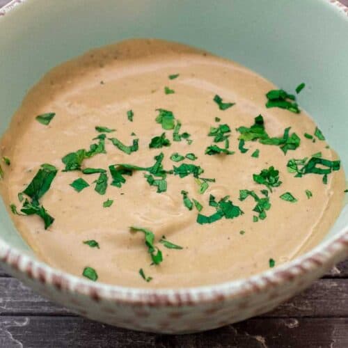 A bowl of Anchovy Sauce, scattered with fresh parsley.