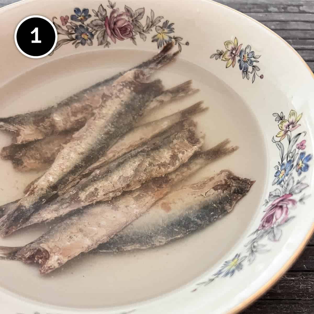 Soaking salted anchovies in cold water for Anchovy Sauce.