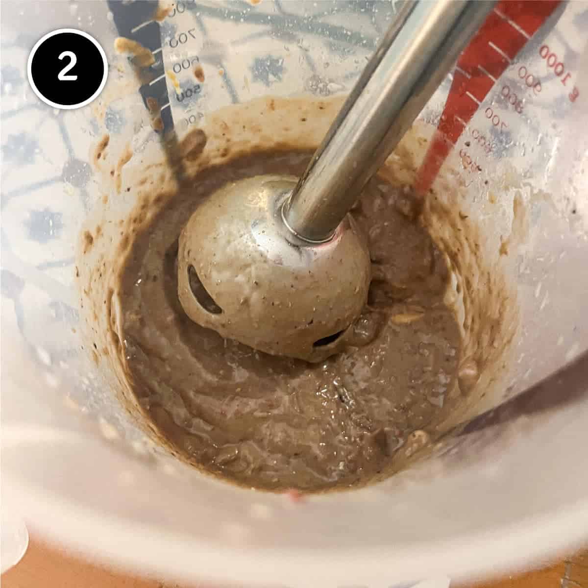 Using a stick blender to bled the anchovies into a paste for Anchovy sauce.