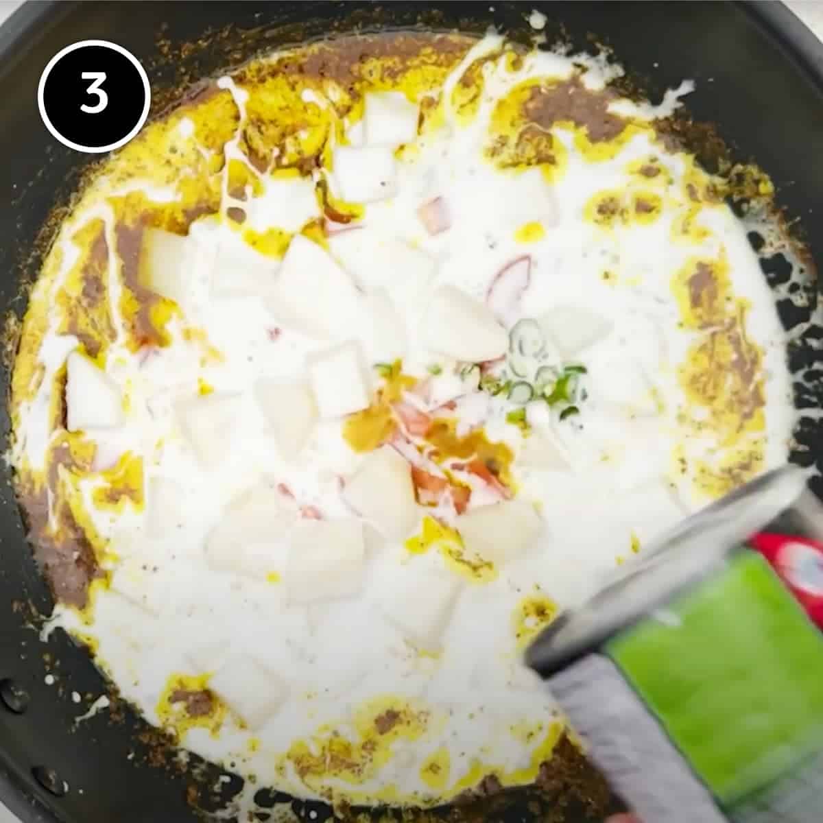 potatoes, tomatoes and coconut milk in a spice paste being cooked for a fish curry | cookeatworld.com