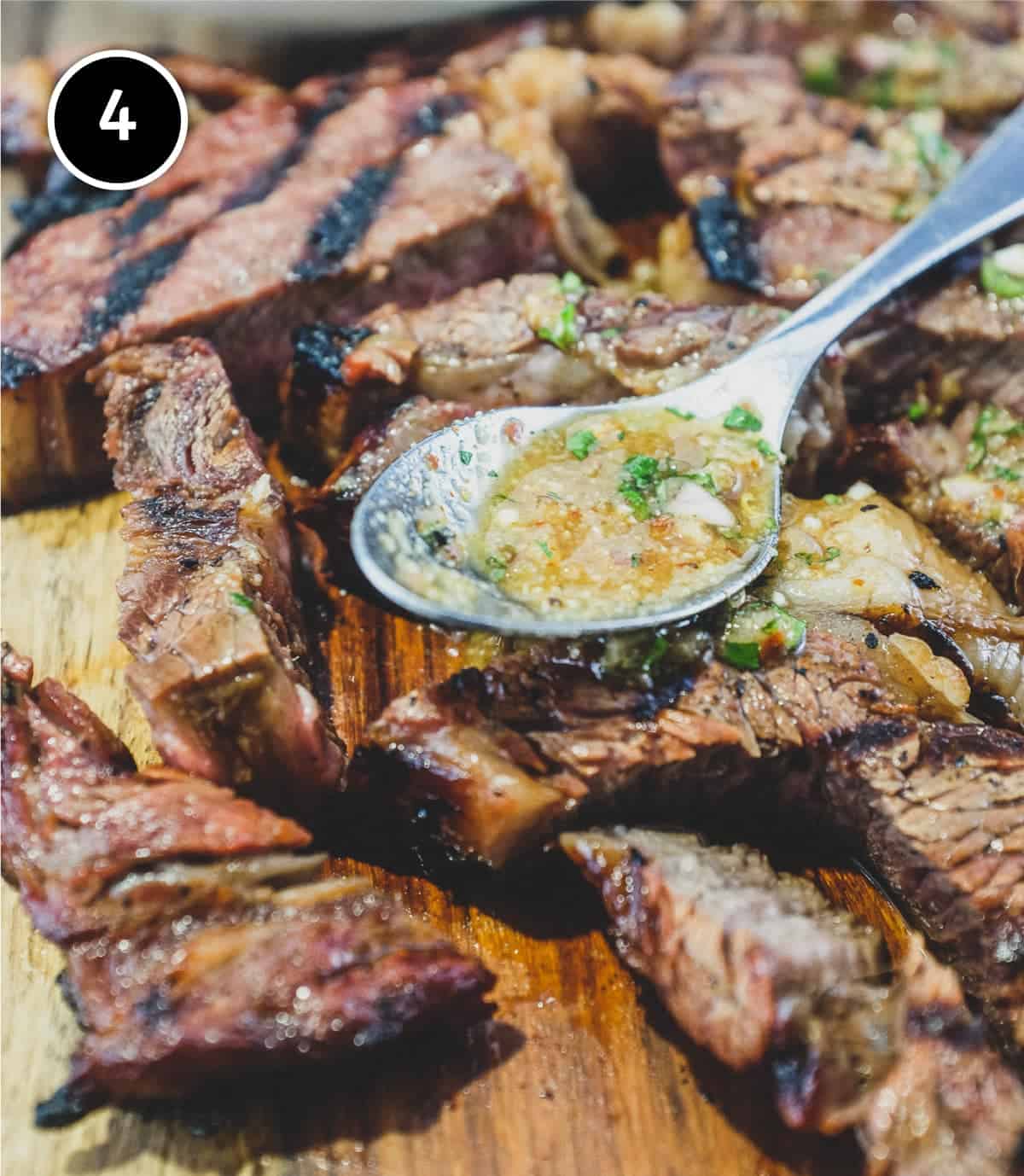 a wooden board with Thai Crying Tiger Beef with Nam Jim Jaew Sauce