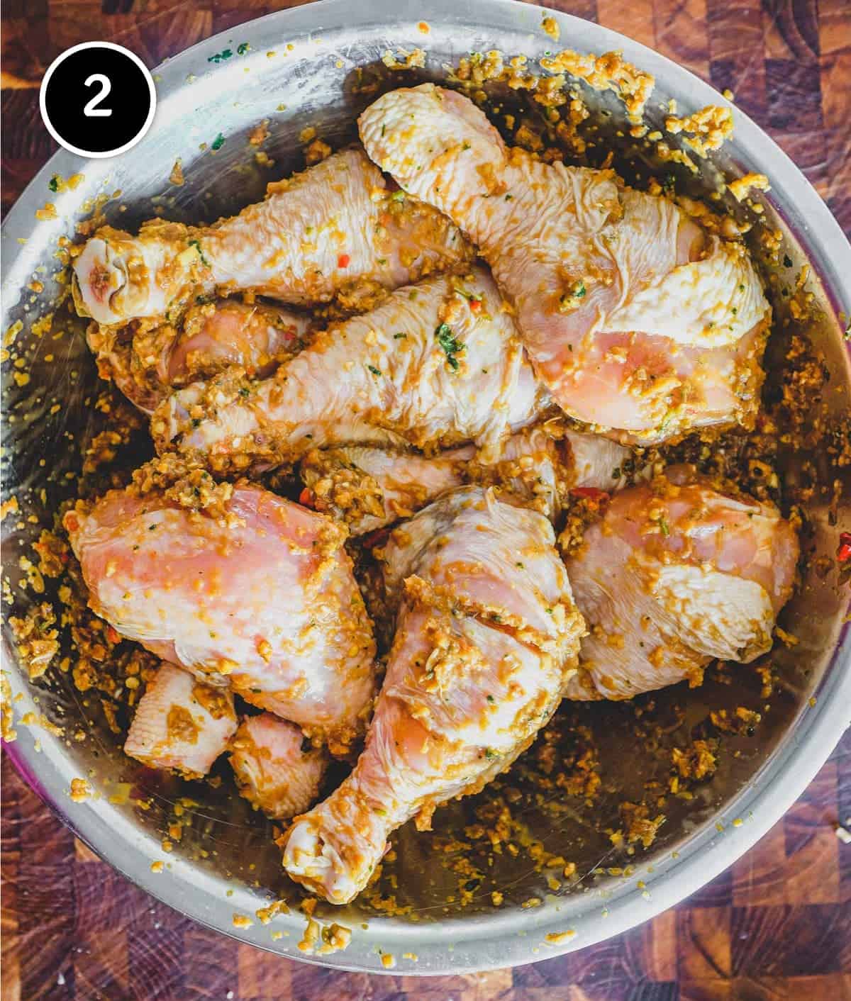 Chicken marinating in various Thai ingredients for Thai-Style Grilled Chicken (Gai Yang)