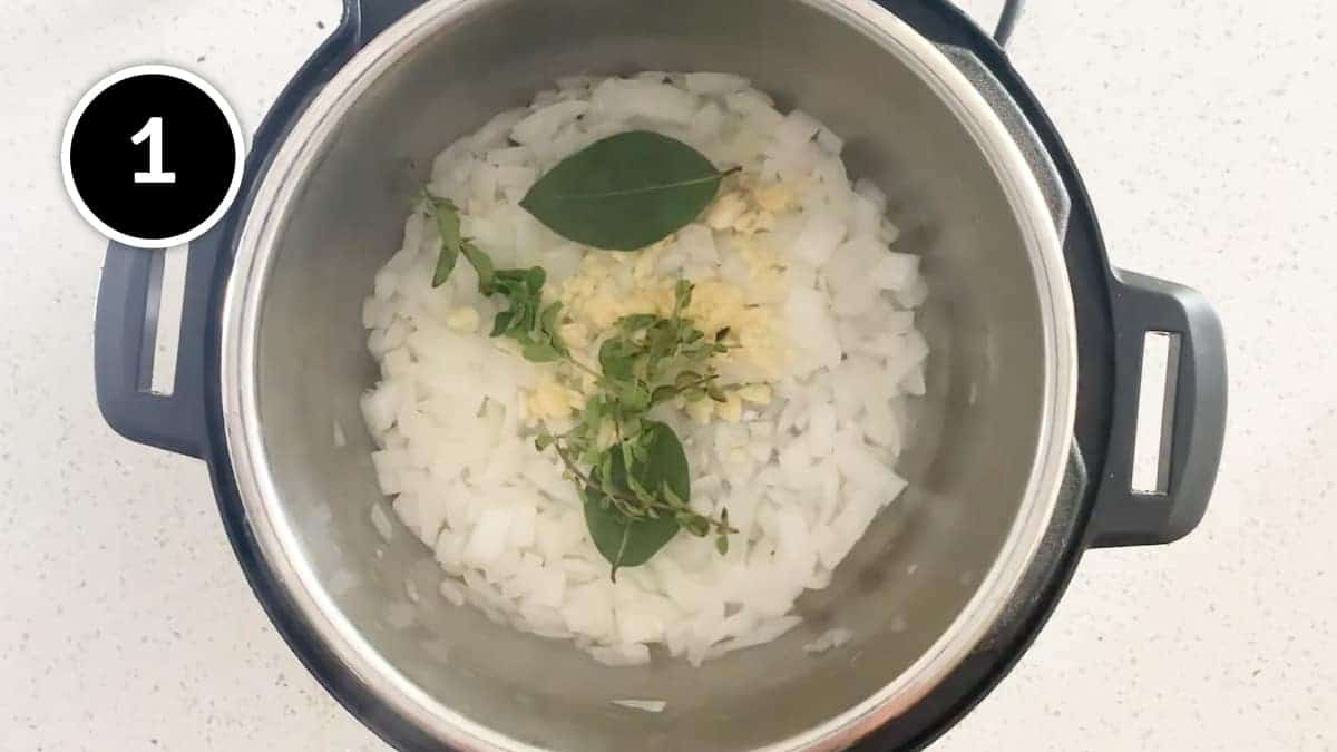 Frying onion, garlic, bay leaves and oregano for a Mexican Pozole Blanco soup