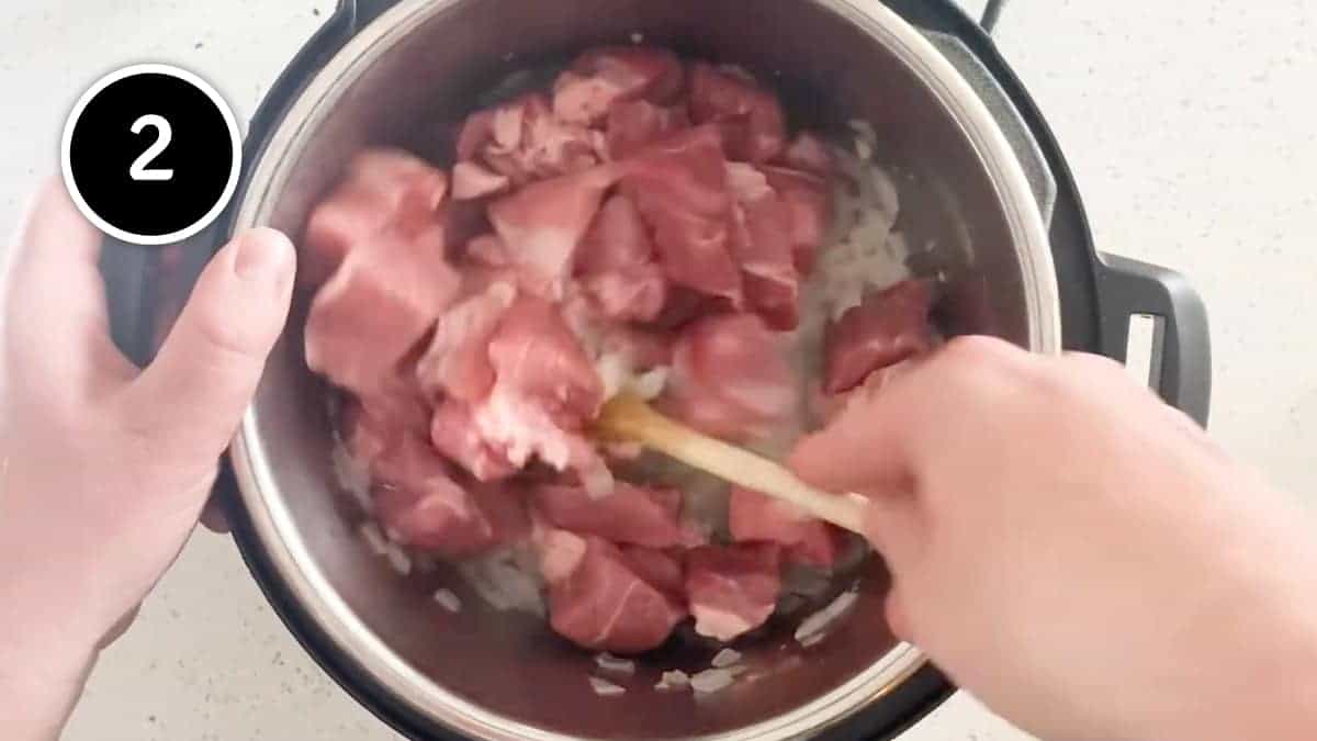 Adding pork to our Mexican Pozole Blanco soup