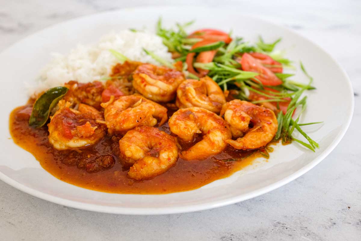 A plate of Sambal Udang (Sambal Prawns) with rice and a salad