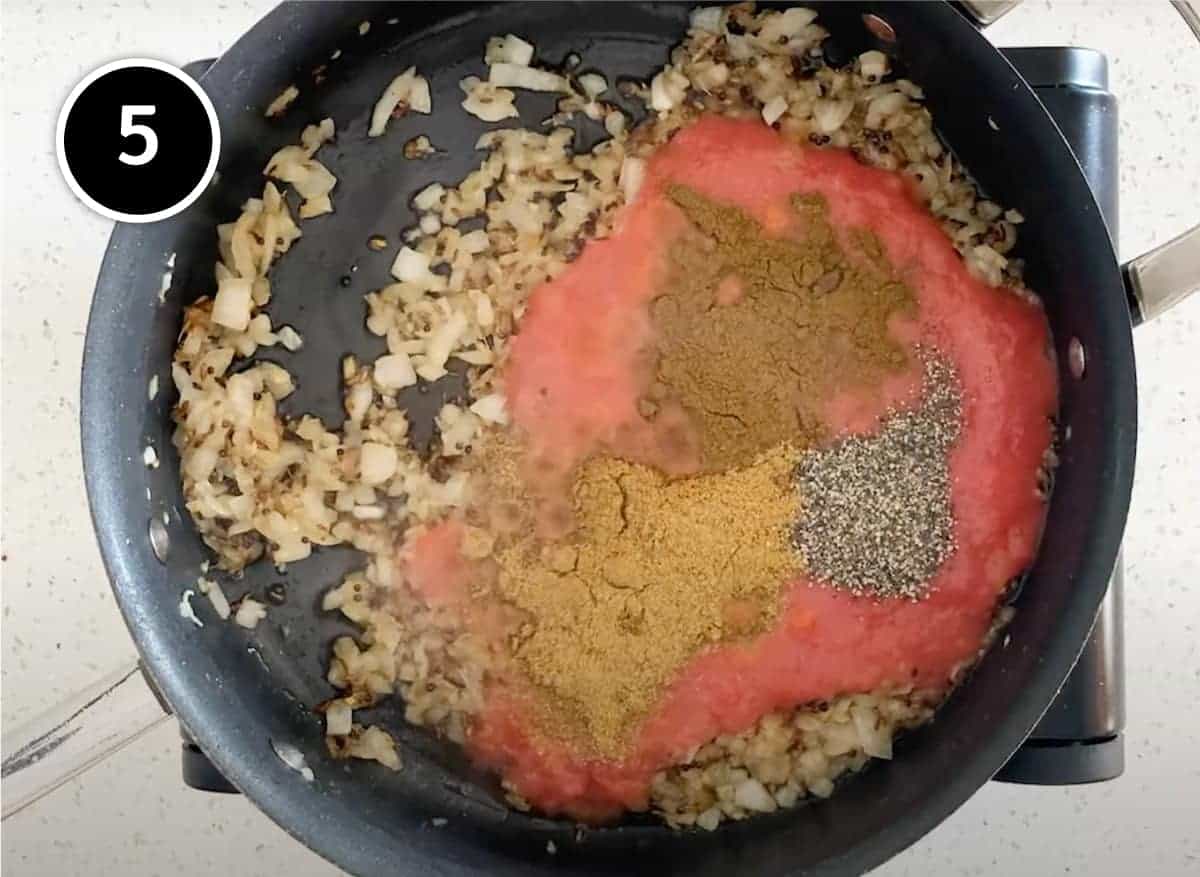 Adding tomato and ground cumin, coriander and black pepper to make the sauce for a Red Moong Dal Curry