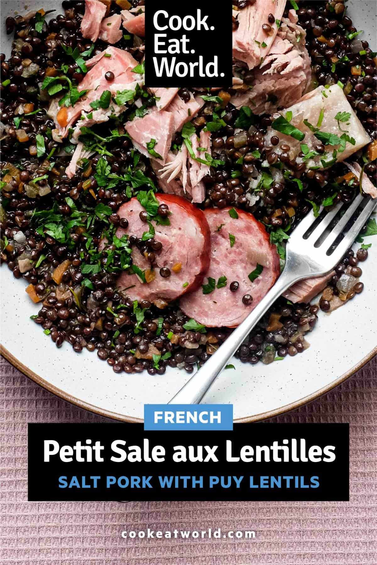 A bowl of lentils with flaked pork and smoked sausages, scattered with fresh parsley | Salt Pork with Puy Lentils (Petit Sale aux Lentilles)