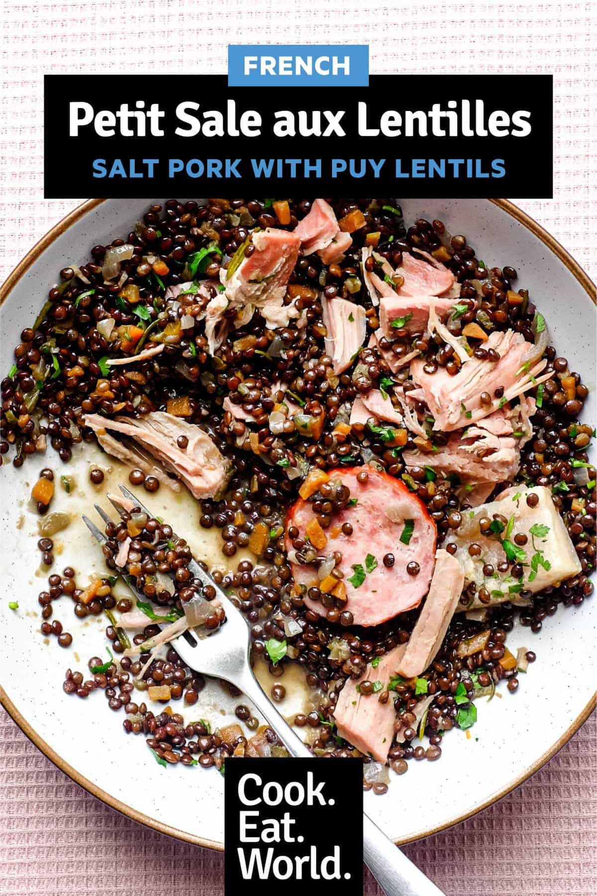 A bowl of lentils with flaked pork and smoked sausages, scattered with fresh parsley | Salt Pork with Puy Lentils (Petit Sale aux Lentilles)