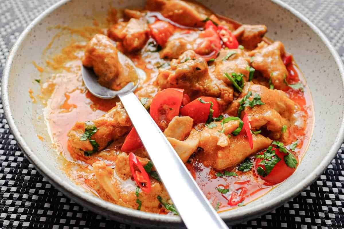 A vibrant peanut satay chicken curry with red chillies and cilantro
