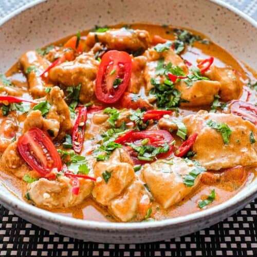 Chicken satay curry served hot with rich coconut peanut sauce and fresh cilantro