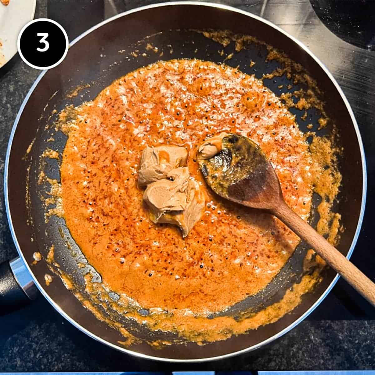 Adding peanut butter to the sauce for a satay chicken curry