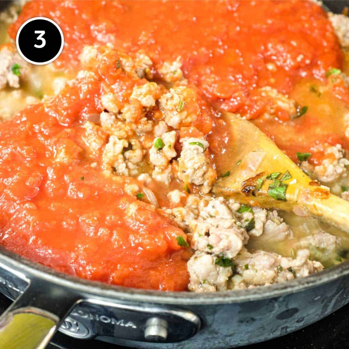 Adding tomato to sausages for Pasta with Sausage Ragu