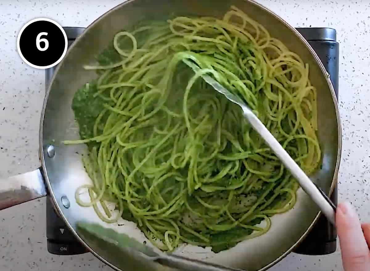 Combining the cabbage pesto with spaghetti in a pan for Pasta with Cavolo Nero & Almonds