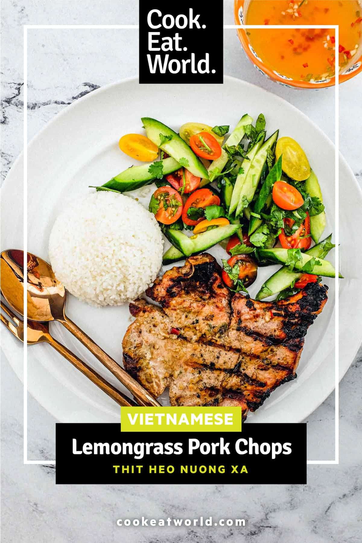 Vietnamese lemongrass pork chops with rice and salad on a plate