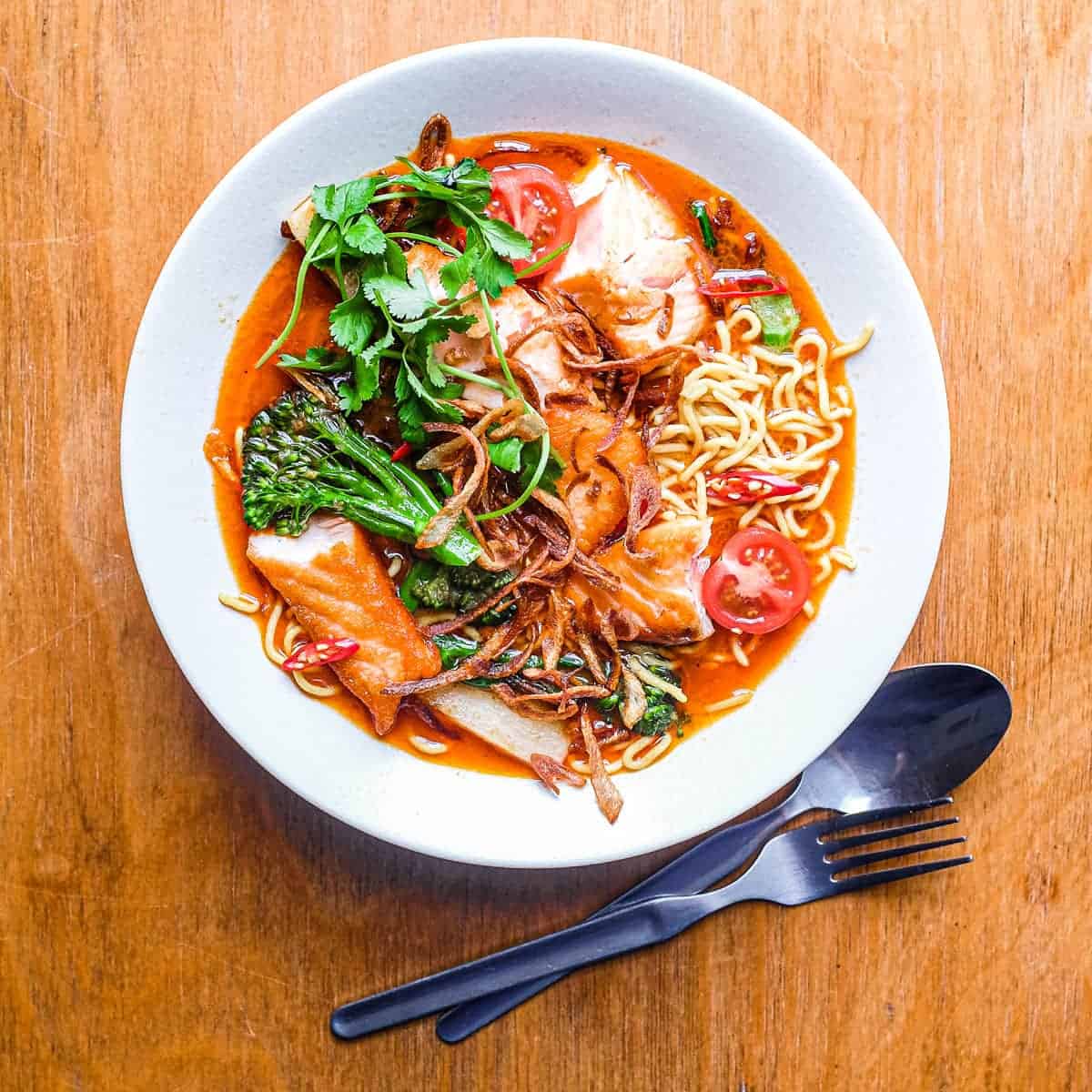 A bowl of Thai Curry Noodle Soup with Salmon