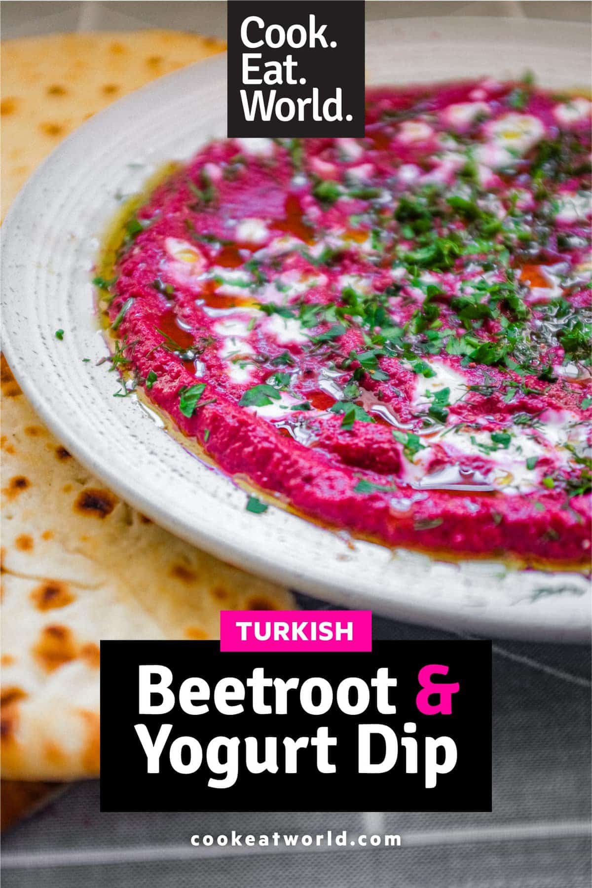 A bowl of beetroot dip scattered with herbs and yoghurt, served with flatbreads