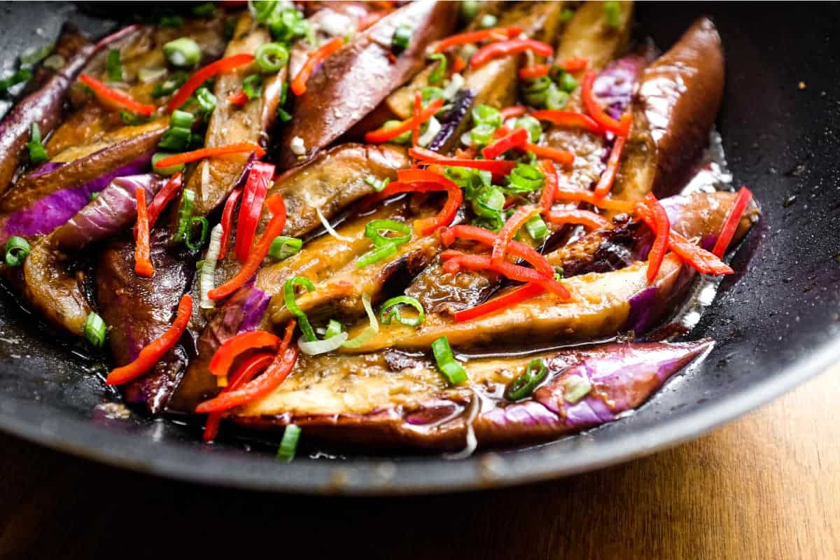 A wok of creamy stir-fried Chinese Eggplant