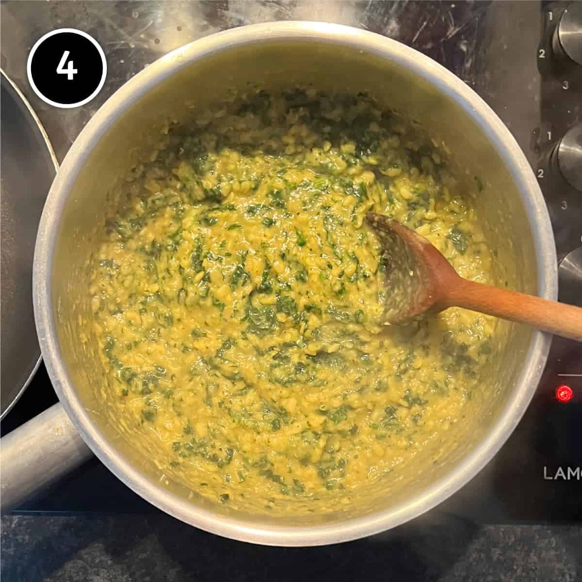 Stirring spinach and lentils together for Spinach Dal (Dal Palak)