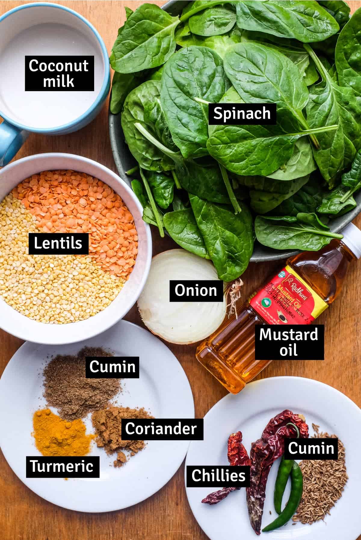 The ingredients for a Spinach Dal (Dal Palak) including lentils, spinach, spices, onion, coconut milk and more.