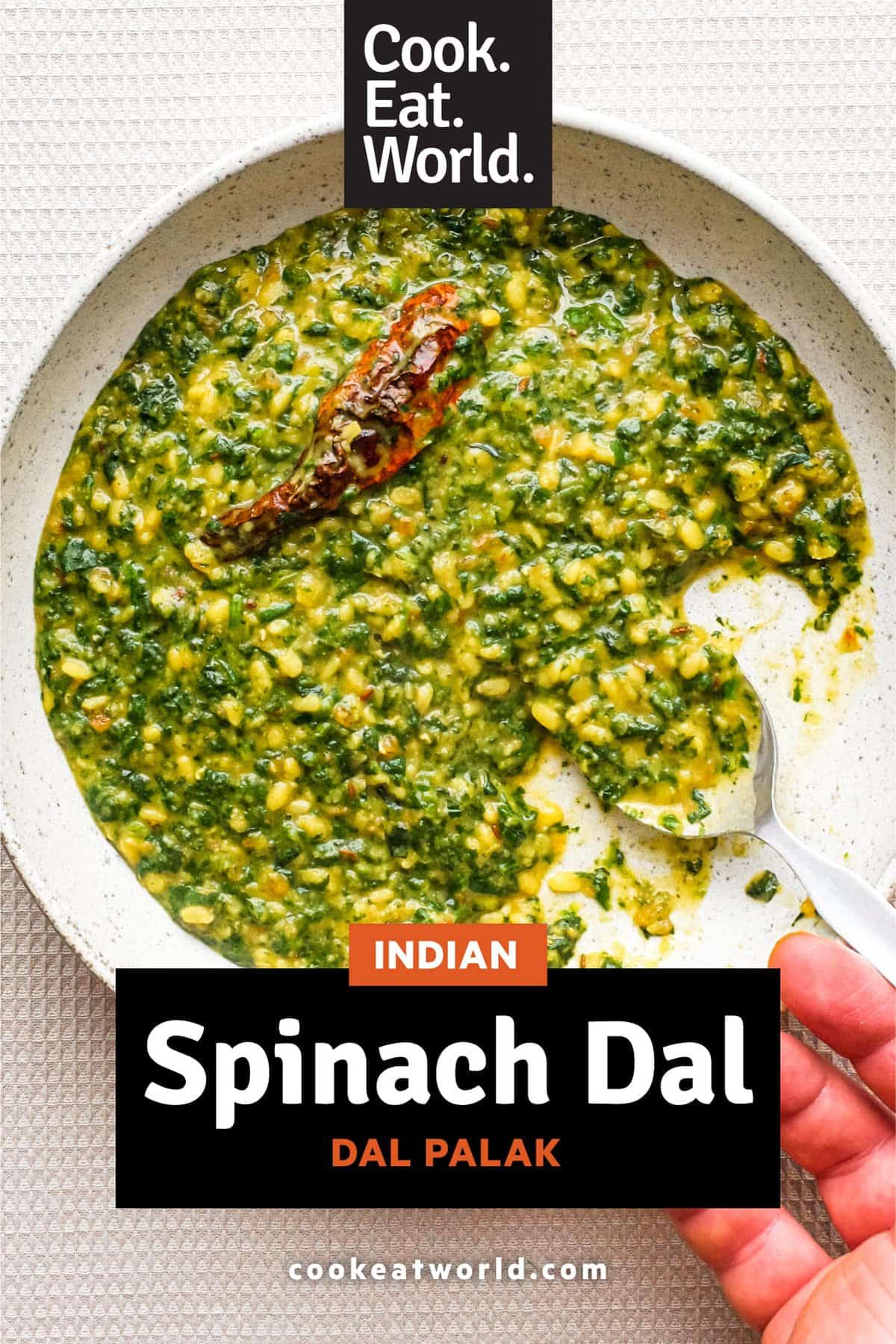 A bowl of Spinach Dal (Dal Palak) with a whole Kashmiri chilli in it.