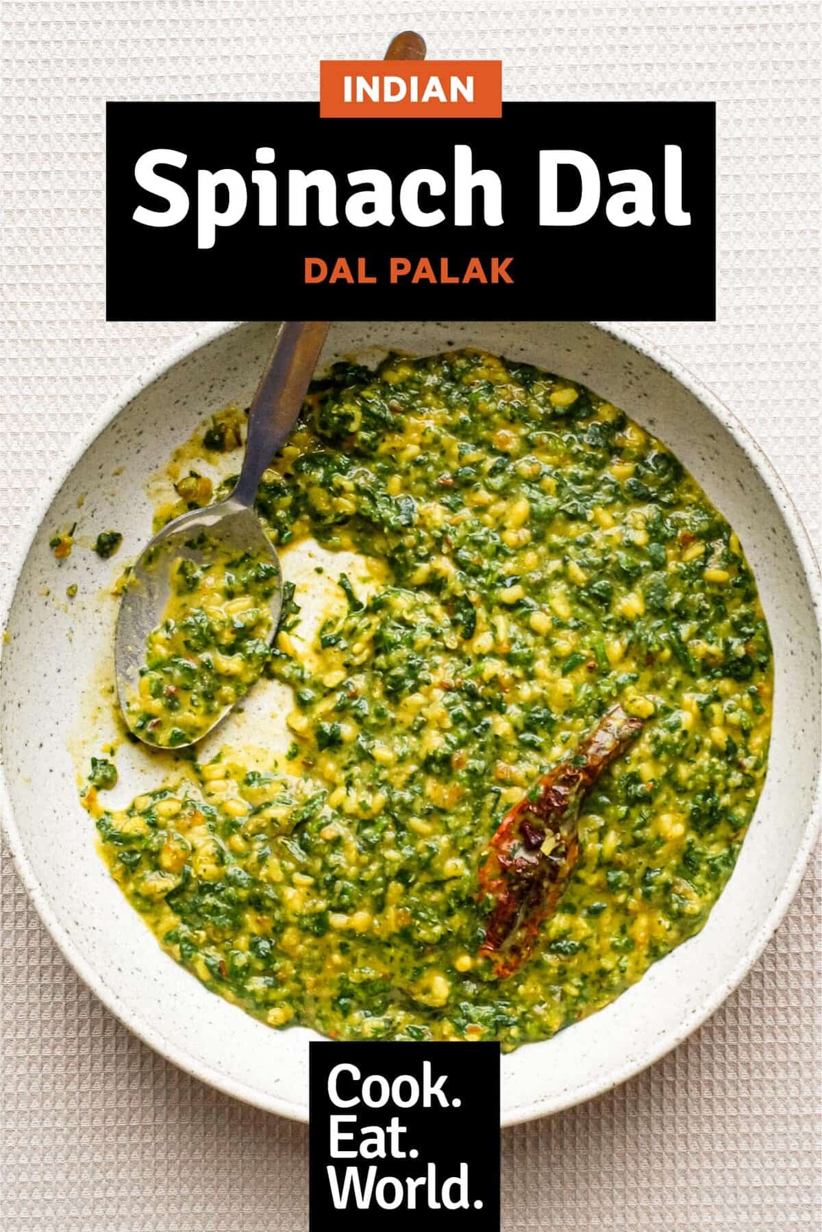 A bowl of Spinach Dal (Dal Palak) with a whole Kashmiri chilli in it.