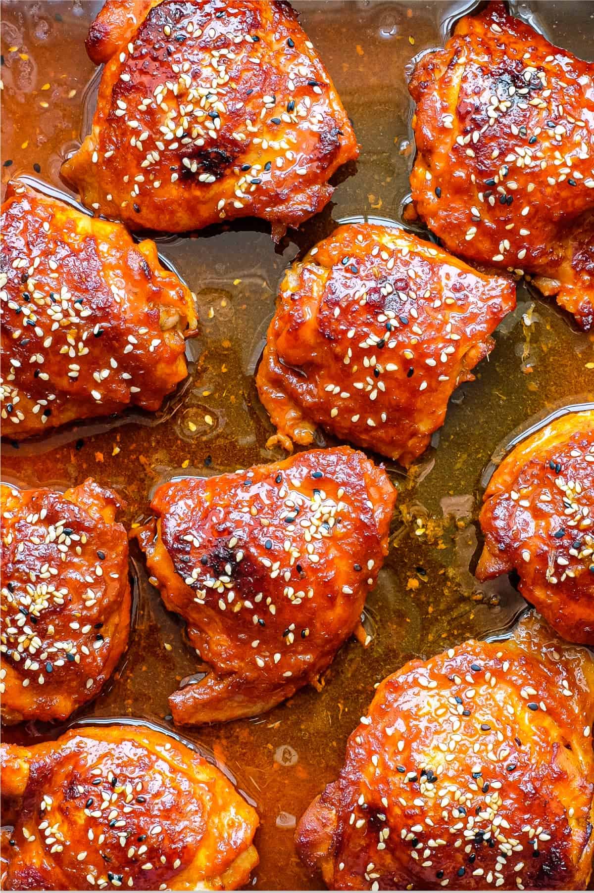 A plate of Korean Gochujang Chicken and chopsticks with salad on the side.