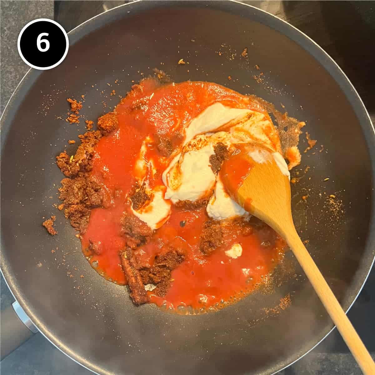 Adding tomato and yoghurt to a fried spice paste