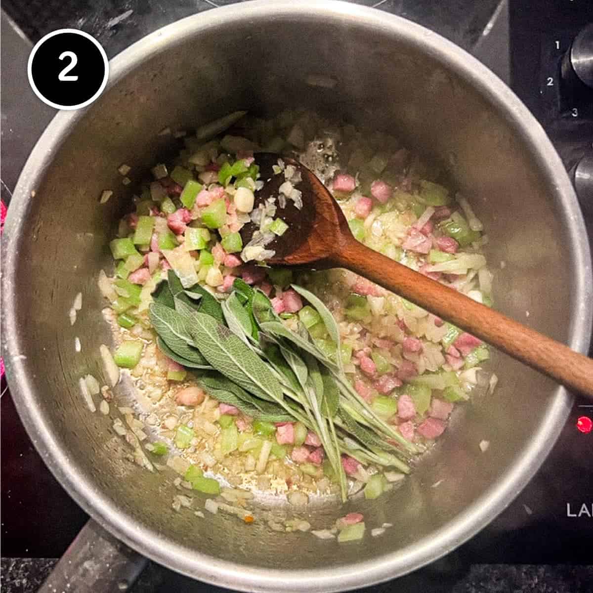 Adding onion, celery and sage to frying pancetta bacon