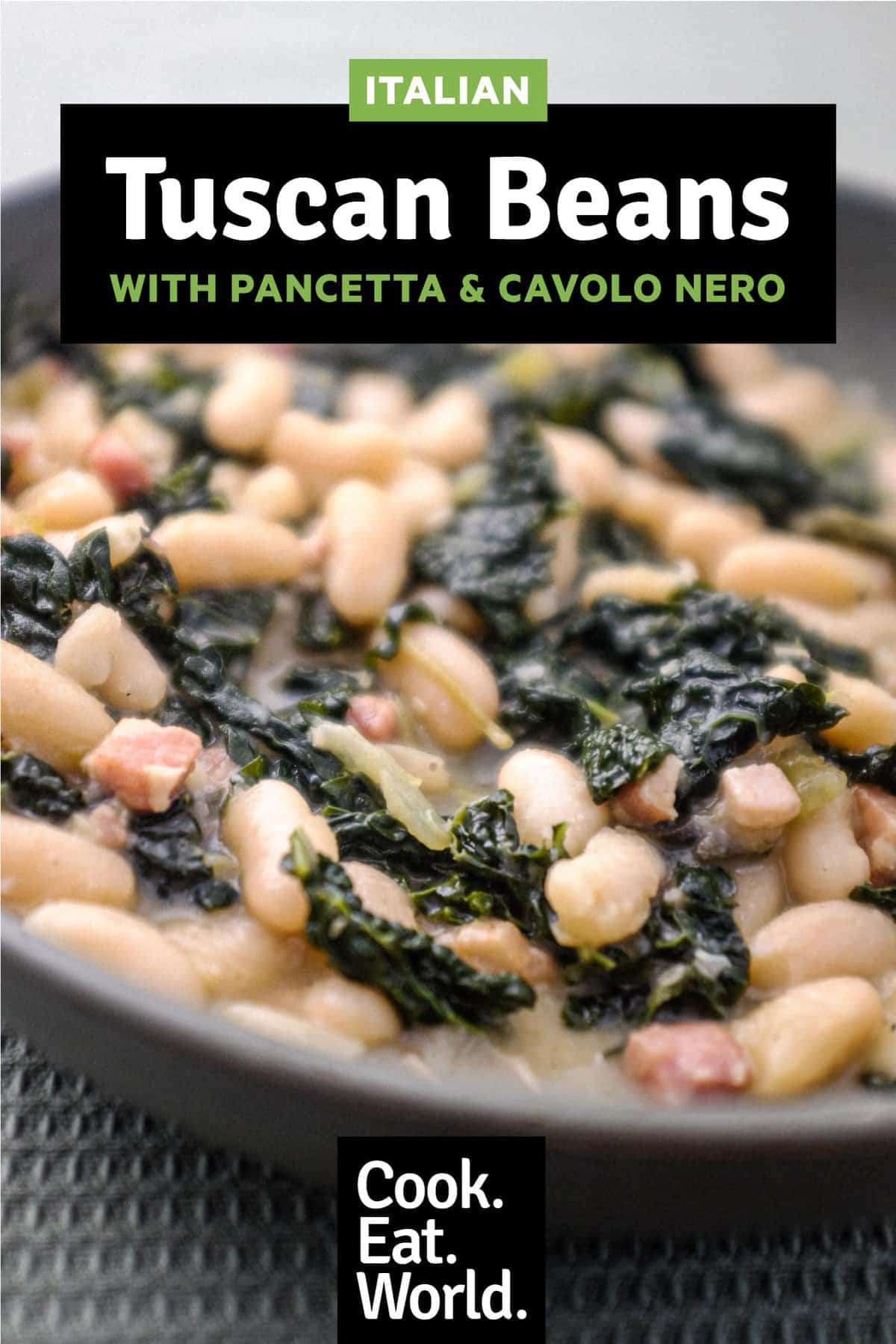 A bowl of Tuscan Beans with pancetta and cavolo nero cabbage in a bowl with a spoon