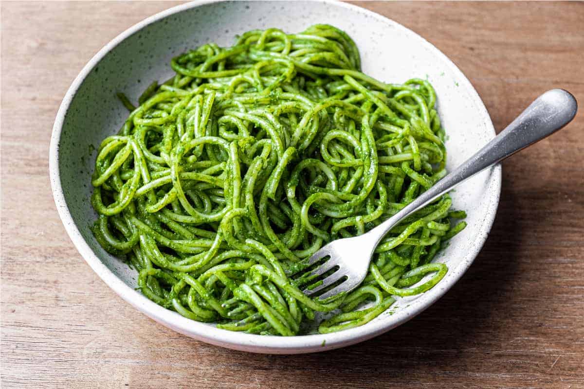 A bowl of spaghetti in a green puree of cavolo nero cabbage