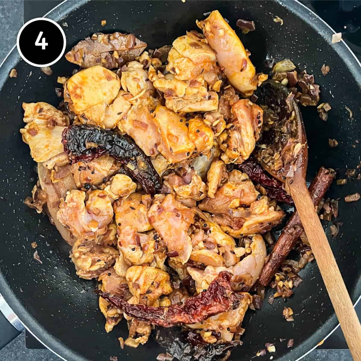 Adding chicken to spiced onion