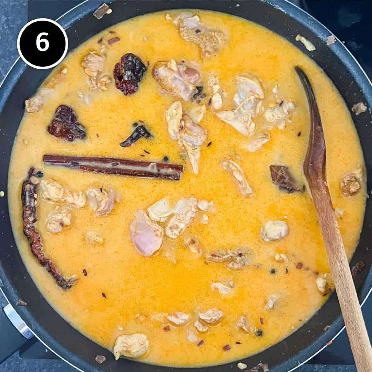 A pan of gently simmering chicken and lentil curry