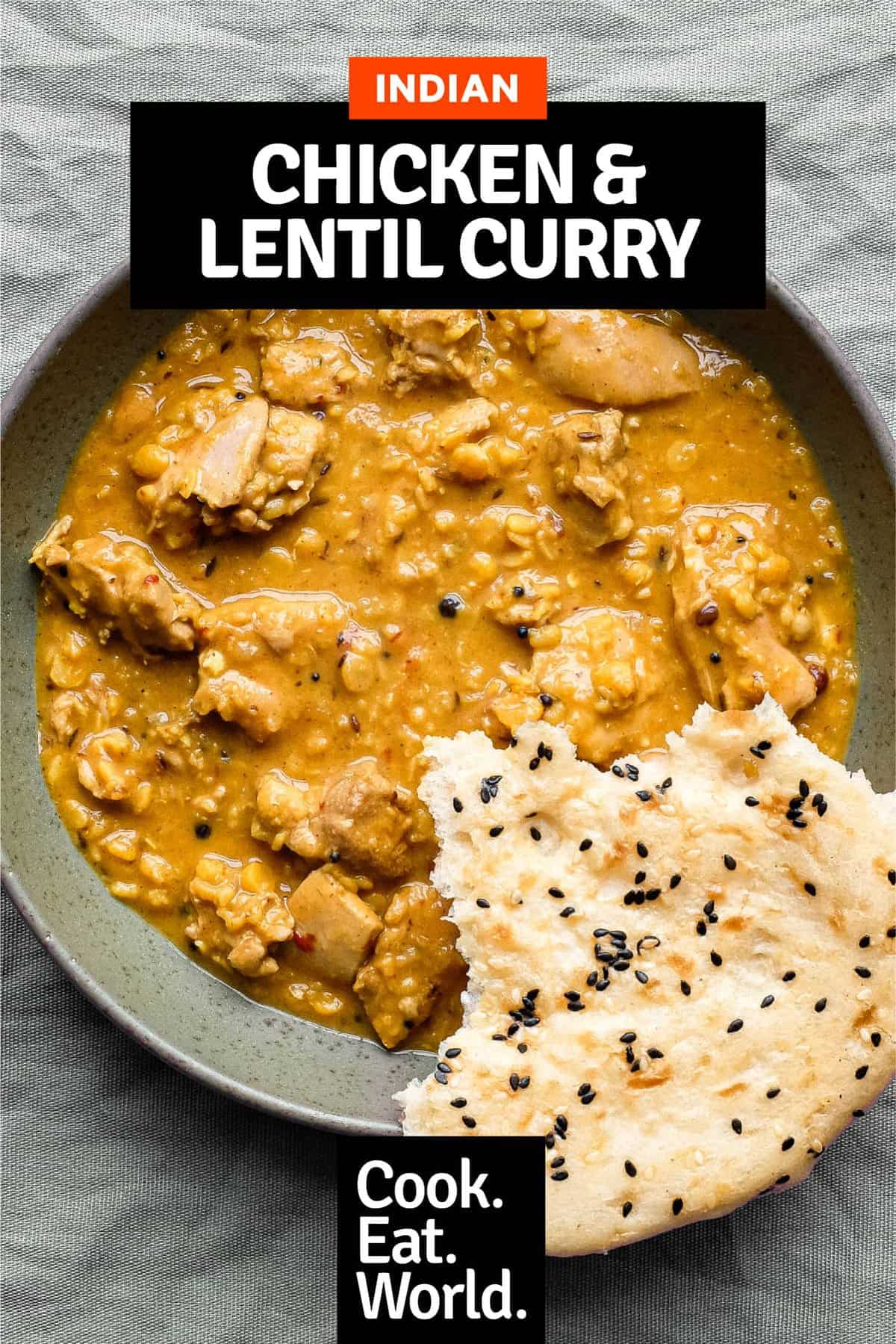 A bowl of lentil curry with a piece of naan bread