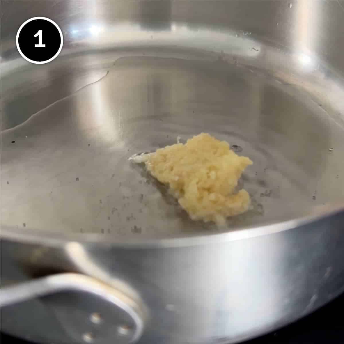 Adding garlic to oil in a pan