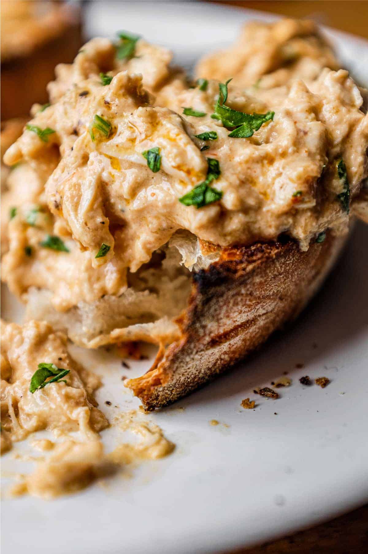 A slice of crusty bread topped with Turkish Circassian Chicken