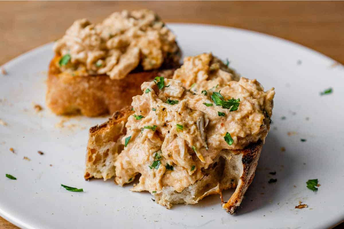 A slice of crusty bread topped with Turkish Circassian Chicken