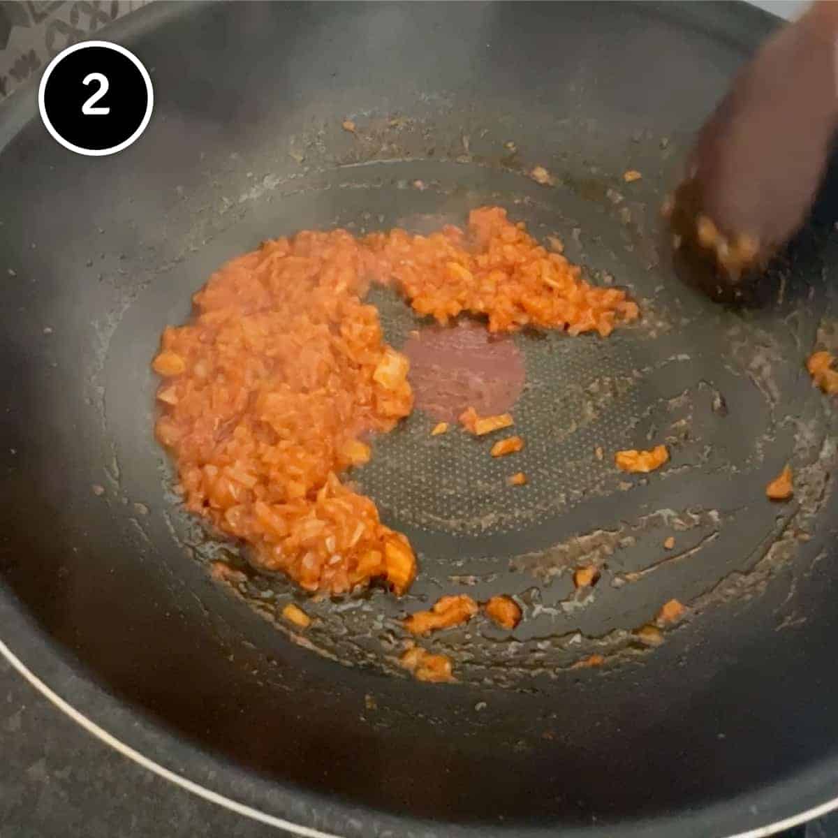 frying onion, garlic and paprika in a pan