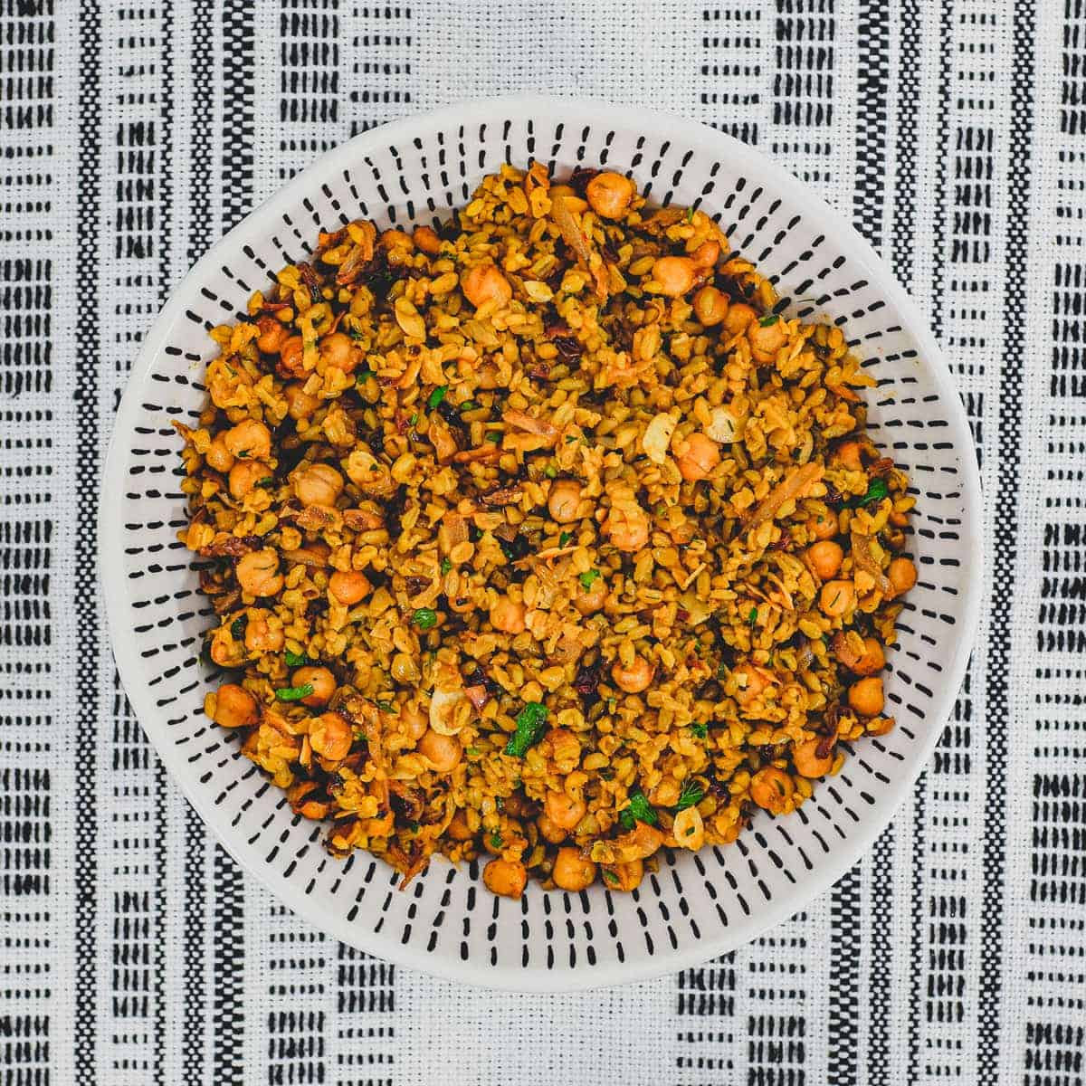 Freekeh cooked with onion and chickpeas in a large serving bowl