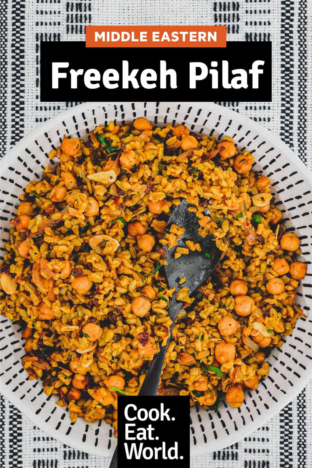 Freekeh cooked with onion and chickpeas in a large serving bowl