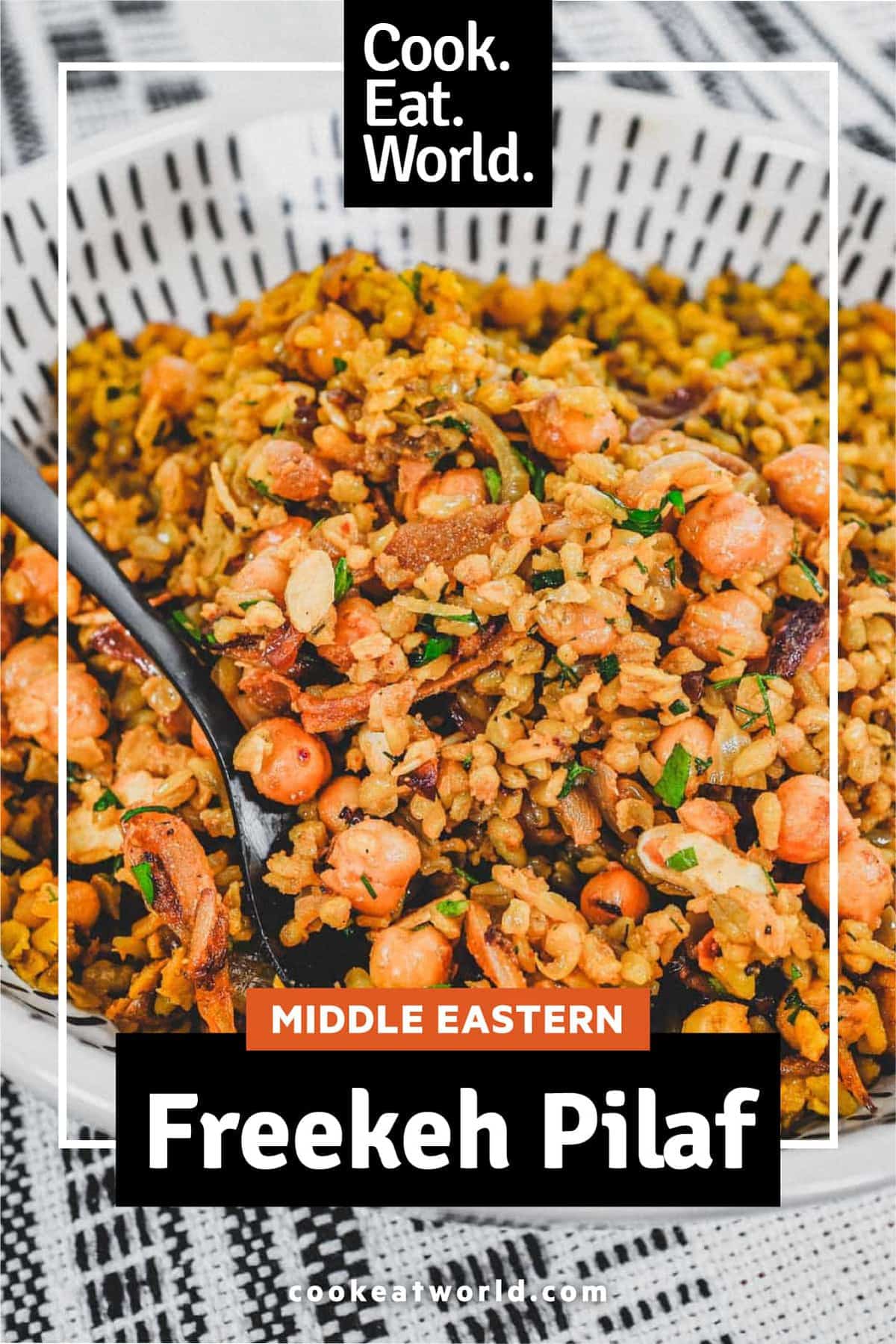 Freekeh cooked with onion and chickpeas in a large serving bowl