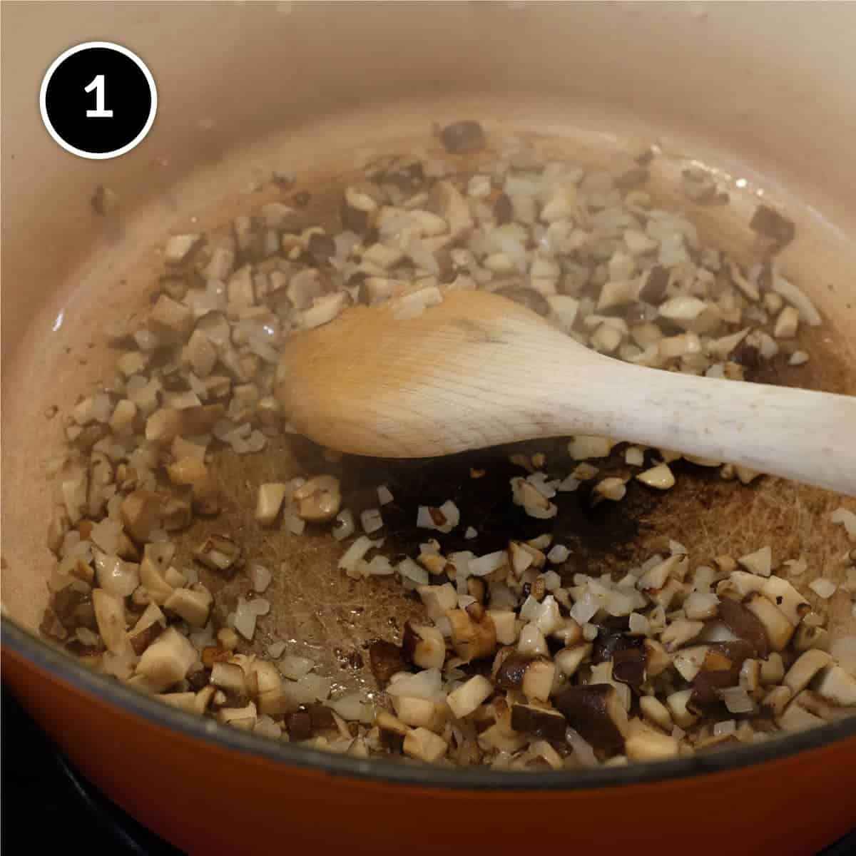 Stirring onion, mushroom and garlic in a large pan