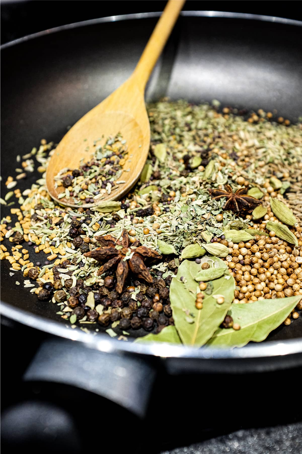 A pan of toasting whole spices