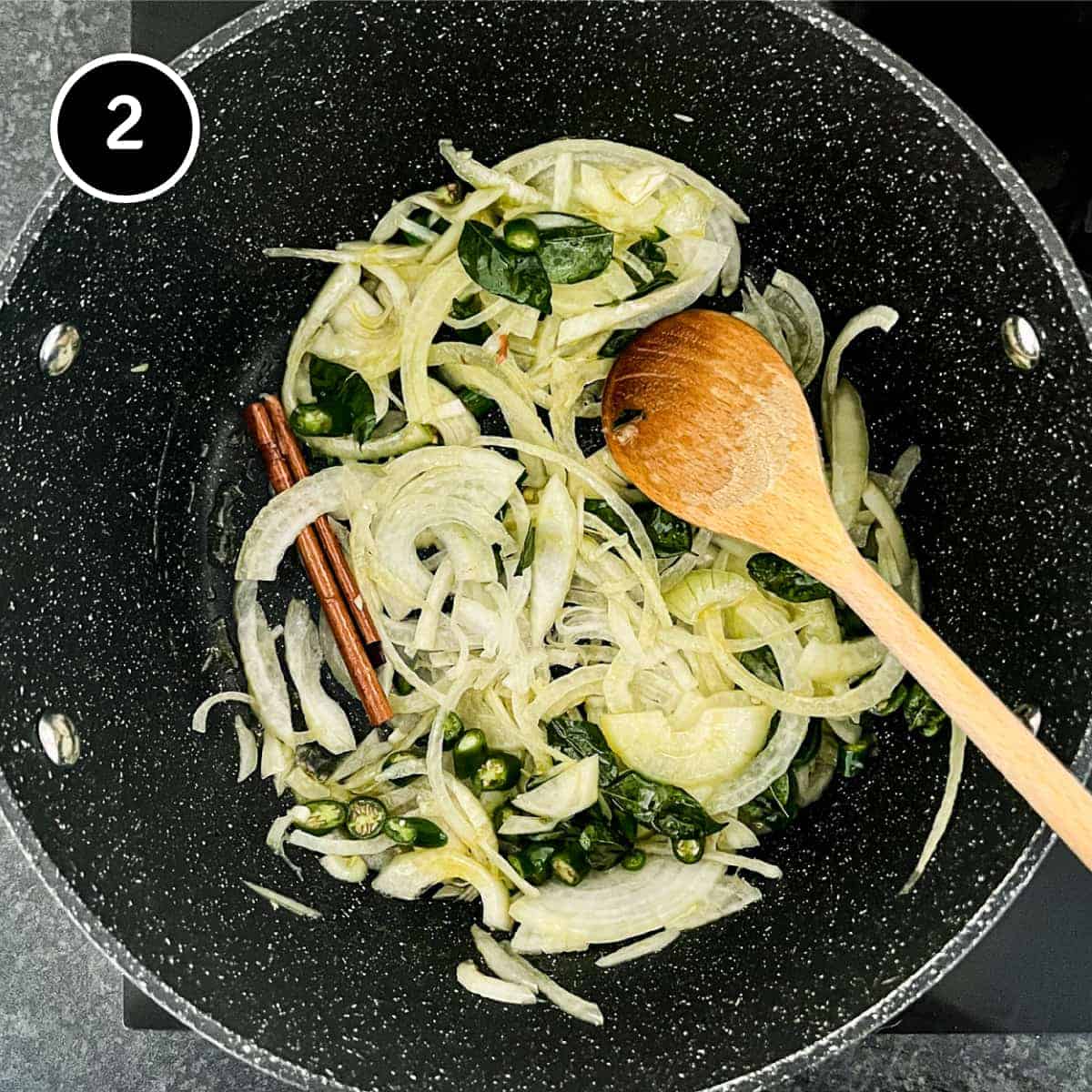 Onion and fresh curry leaves with cinnamon srying in a pan