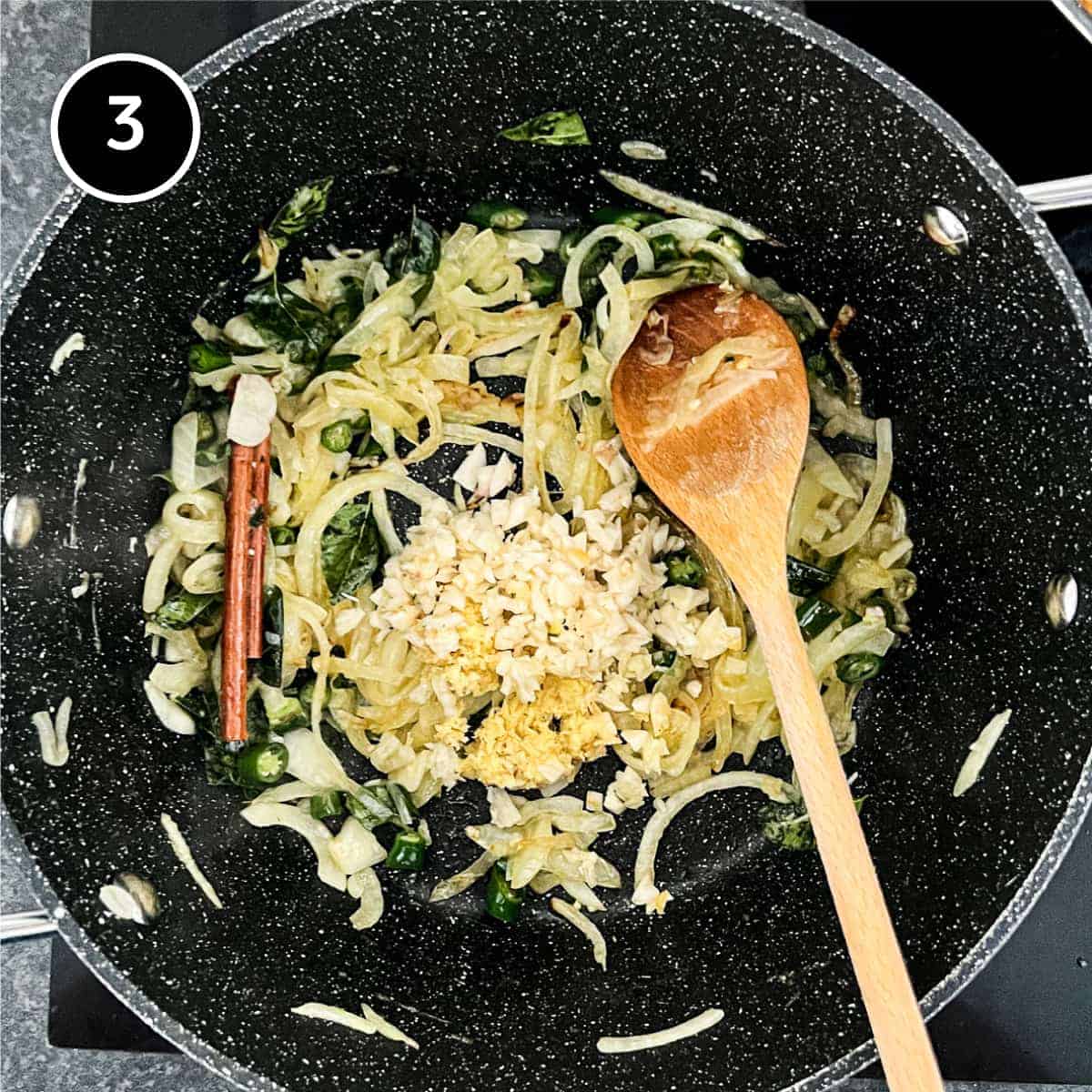 Garlic being added to fried onion in a pan