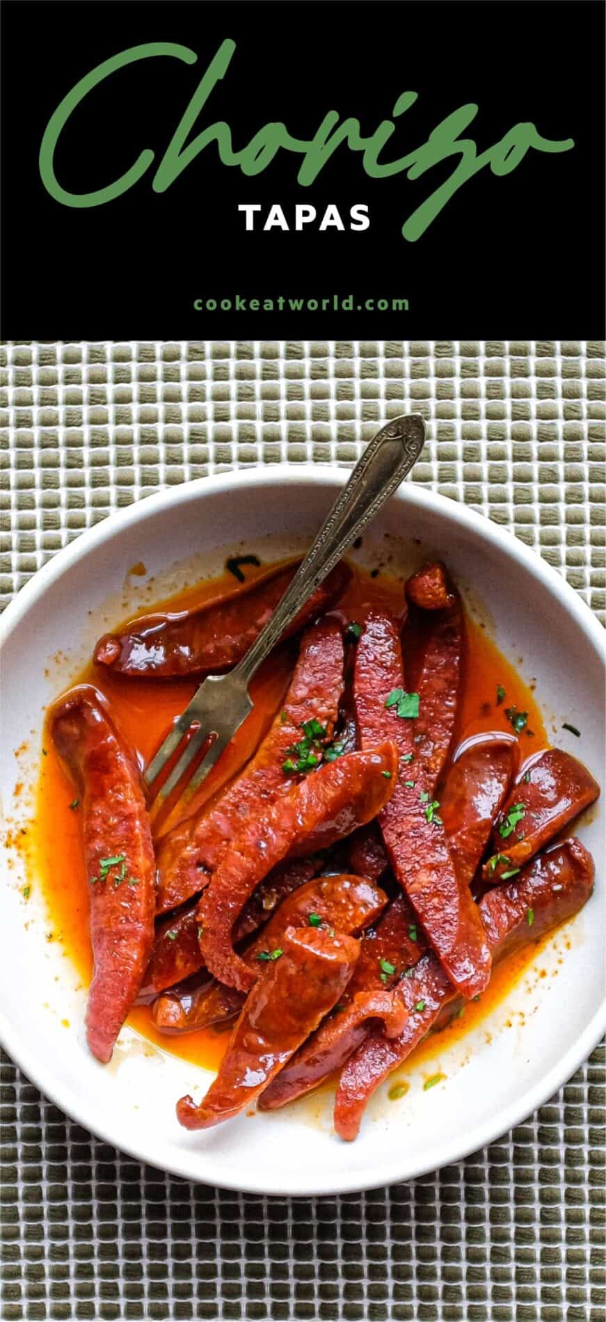 A small tapas bowl of Chorizo in a fino sherry sauce with a small tapas fork