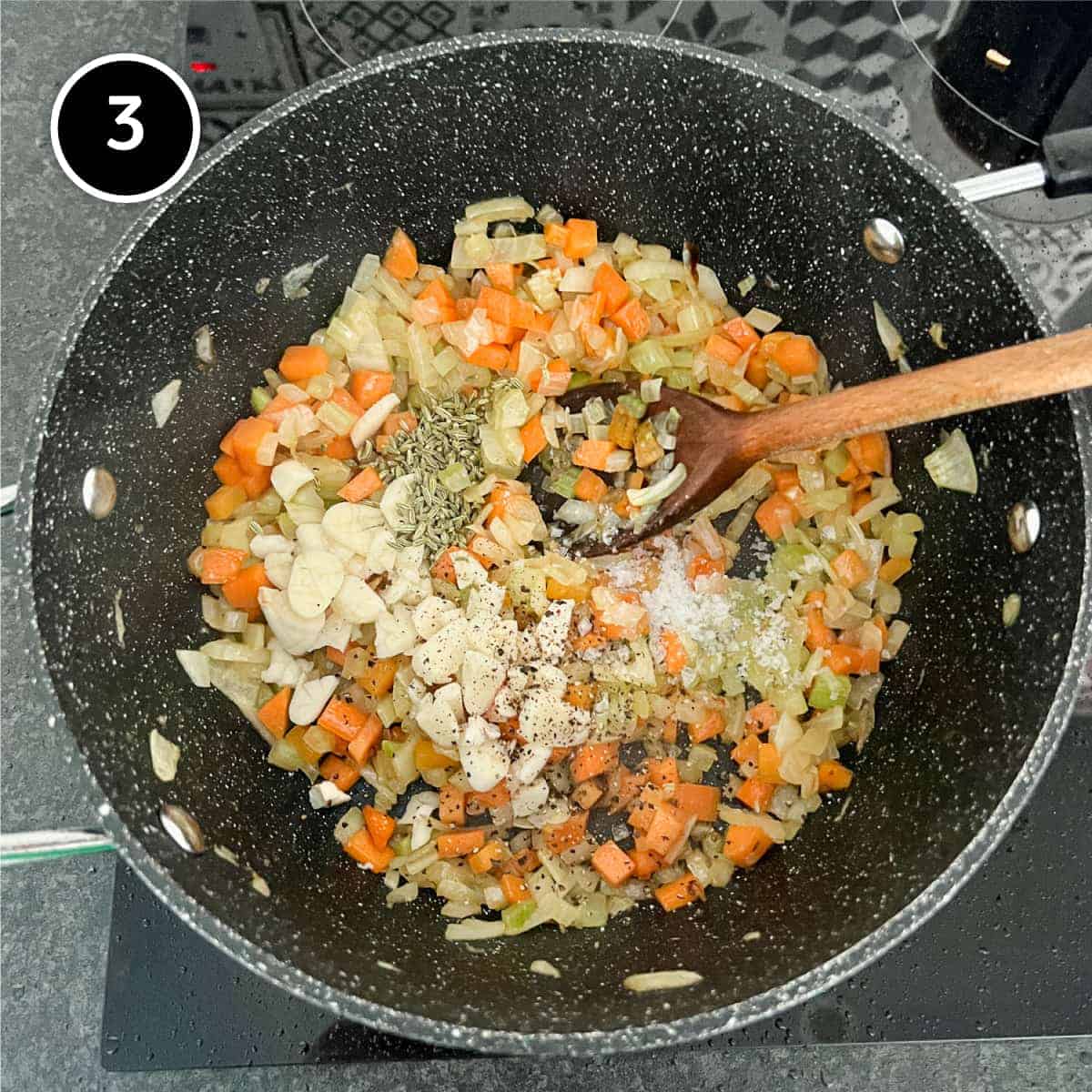 Garlic and fennel is added to a pan of sautéed vegetables.