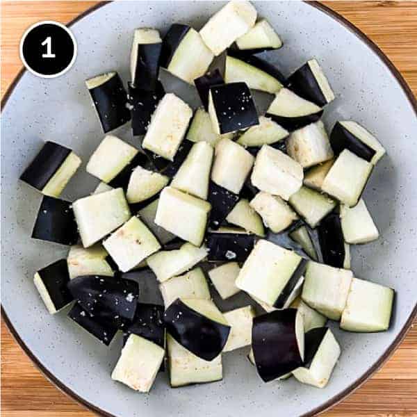 Diced eggplant is sprinkled with salt